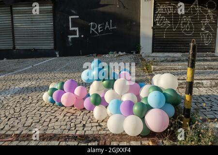 colorful balloons with an abandoned and dirty property in the background in northern Brazil Stock Photo