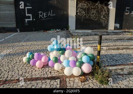 colorful balloons with an abandoned and dirty property in the background in northern Brazil Stock Photo