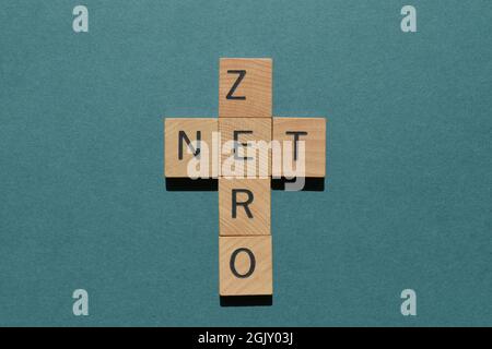 Net Zero, words in wooden alphabet letters in crossword form isolated on green background Stock Photo