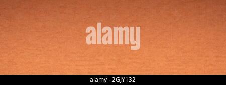 background and texture of orange handmade Indian rag paper created from recycled cotton fabric, panoramic banner Stock Photo