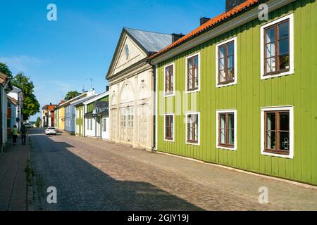 Vastervik, Sweden - 08.23.2021: Street near the center with old, traditional colorful wooden houses in scandinavian style. Sunny summer day. Stock Photo