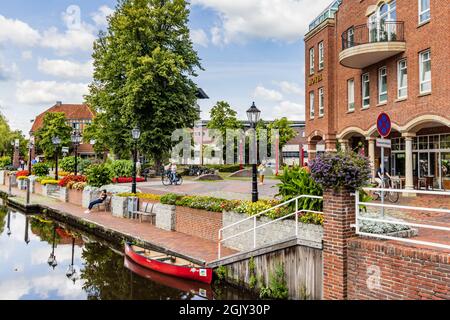 Papenburg, Germany - August 24, 2021: Colorful old village centre of Papenburg along river Ems with canals, little brdiges and ancient ships in Lower Saxony in Germany