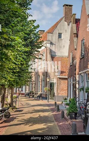 Hasselt, The Netherlands, August 11, 2021: Heerengracht canal in the old town, lined with trees and houses with brick facades Stock Photo