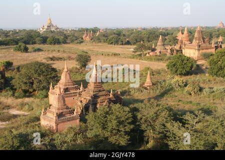 An aerial view of beautiful Buddhist temples surrounded by trees in Bagan, Myanmar Stock Photo