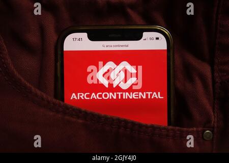 KONSKIE, POLAND - September 04, 2021: Arca Continental company logo displayed on mobile phone hidden in jeans pocket Stock Photo