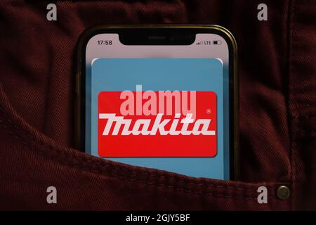 KONSKIE, POLAND - September 04, 2021: Makita Corporation logo displayed on mobile phone hidden in jeans pocket Stock Photo