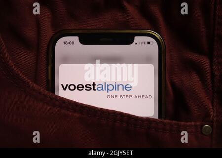 KONSKIE, POLAND - September 04, 2021: Voestalpine AG logo displayed on mobile phone hidden in jeans pocket Stock Photo