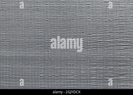 Close-up of gray plastic weave tarp material. Abstract high resolution full frame textured background in black and white. Copy space. Stock Photo