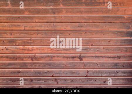 Front view of weathered wood boards wall painted in red. High resolution full frame textured background. Copy space. Stock Photo