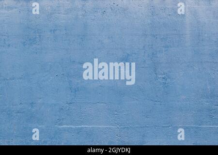 Close-up of plastered concrete wall painted in light blue. Abstract high resolution full frame textured background. Copy space. Stock Photo