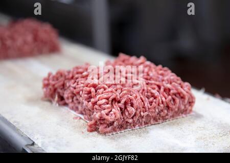 Meat-grinder, grinding fresh meat into minced meat Stock Photo - Alamy