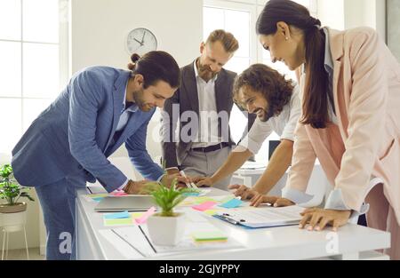 Creative team of smart expert CEOs working together to plan new business strategy. Stock Photo