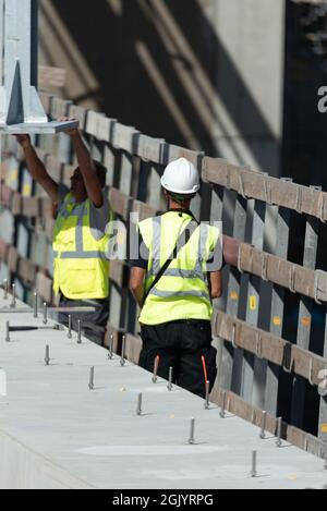 Vienna, Austria - August 2, 2021. A worker in working clothes during construction work on the road repair. Stock Photo