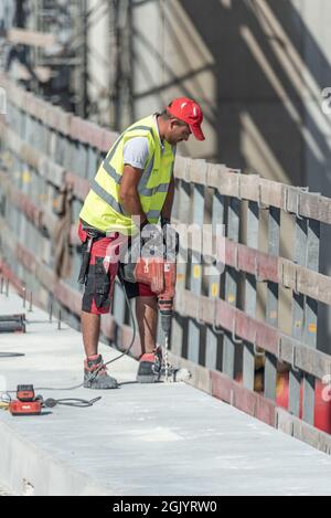 Vienna, Austria - August 2, 2021. A worker in working clothes during construction work on the road repair. Stock Photo