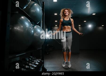 Athlete is engaged in cardio training hall jumping on a rope. Stock Photo