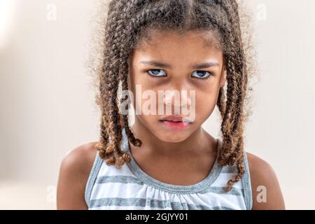 Little girl doing facial expressions face on white Stock Photo