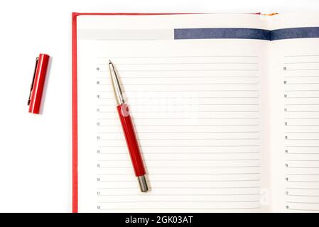 Open clean red notebook with red pen. Notebook, Education, school, college. Gaining knowledge, planning. View from above. Copy space Stock Photo