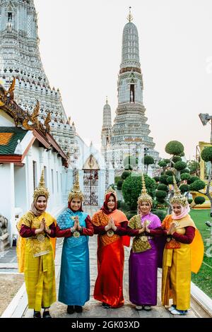 Bangkok, Thailand - January 16,2020. Beautiful Thai women in colorful traditional dress at Buddhist Wat Arun temple.Culture of Thailand,typical costum Stock Photo