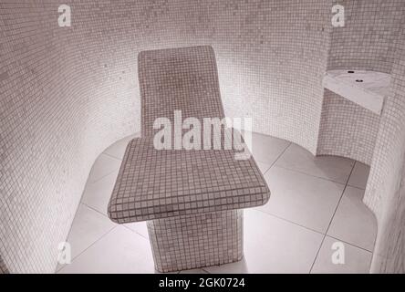 Hammam, traditional Turkish bath relaxation area with tiled seat and walls, illuminated from below; in luxurious spa Stock Photo