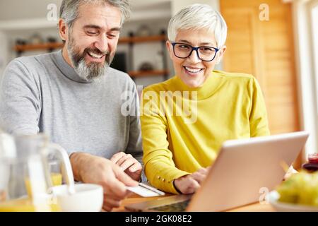 senior couple happy laptop online shopping debit credit card order ecommerce Stock Photo