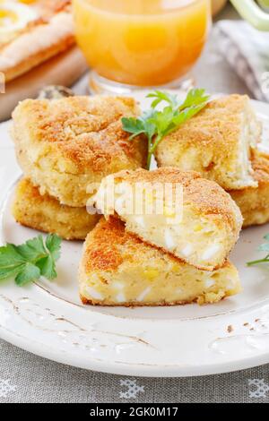 Traditional croquettes stuffed with eggs. Party dish Stock Photo