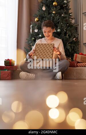 Excited Woman Opening Christmas Gift Box during Holiday Celebration ...