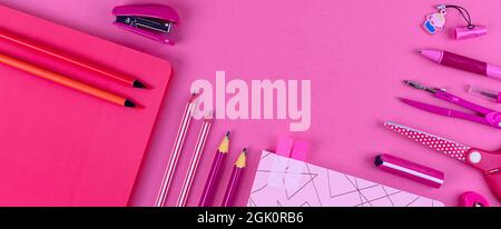 Pink school stationery on a pink background. Creative back to school concept. Banner. Flat lay. Stock Photo
