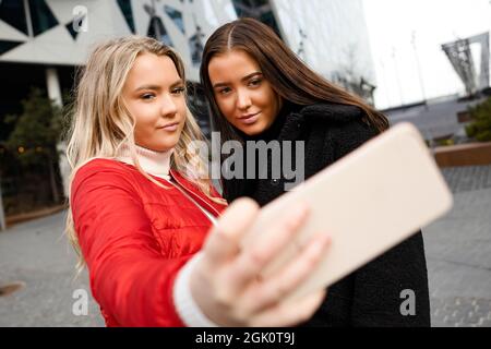 Friends Taking Selfie Through Smartphone In City Stock Photo