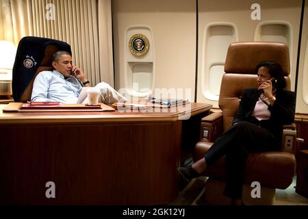 President Barack Obama, aboard Air Force One, talks on the phone with President Hamid Karzai of Afghanistan, who was unable to travel from Kabul to meet with President Obama at Bagram Airfield, Afghanistan, Sunday, May 25, 2014. National Security Advisor Susan E. Rice sits at right. (Official White House Photo by Pete Souza) Stock Photo