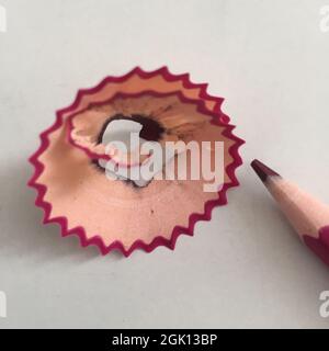 Pencil Shavings and Colored Pencil on White Background Stock Photo