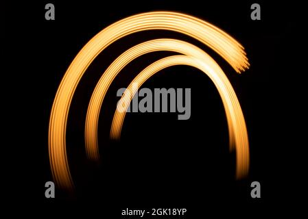 Golden gate.Abstract line from LED light.On the black background.. Stock Photo