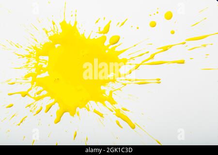 Yellow paint spots on paper, colorfull artistic image on white background Stock Photo