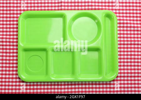 Empty serving tray for food on tablecloth. Concept of school lunch