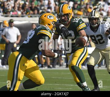 Santa Clara, CA, USA. 26th Sep, 2021. Green Bay Packers' AJ Dillon (28) is  tackled by San Francisco 49ers' Azeez Al-Shaair (51) and San Francisco 49ers'  Emmanuel Moseley (4) after a pass