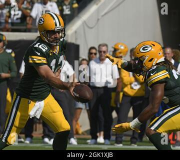 Santa Clara, CA, USA. 26th Sep, 2021. Green Bay Packers' AJ Dillon (28) is  tackled by San Francisco 49ers' Azeez Al-Shaair (51) and San Francisco 49ers'  Emmanuel Moseley (4) after a pass