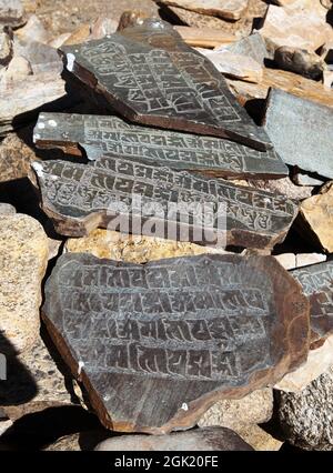 Mani wall and stone with buddhist symbols Stock Photo