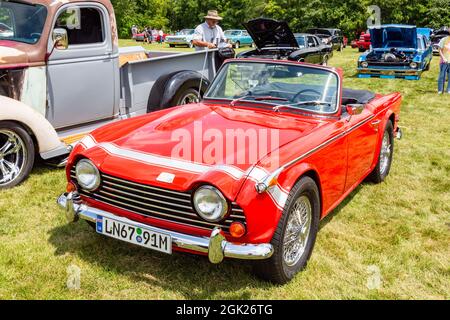 An antique red 1968 Triumph TR250 convertible sports car on display at a car show in Fort Wayne, Indiana, USA. Stock Photo