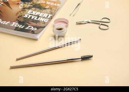Fashion magazine, henna and tools for eyebrows correction on color background Stock Photo
