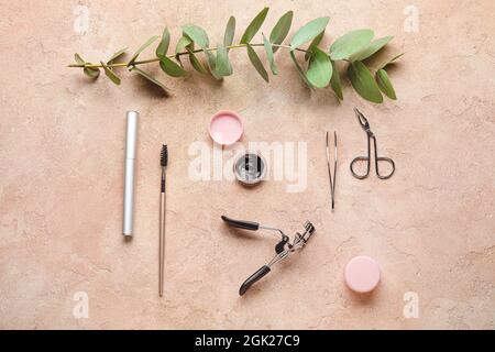 Henna and tools for eyebrows and eyelashes correction on color background Stock Photo