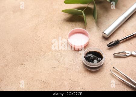 Henna and tools for eyebrows and eyelashes correction on color background, closeup Stock Photo