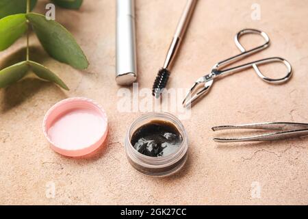 Henna and tools for eyebrows and eyelashes correction on color background, closeup Stock Photo