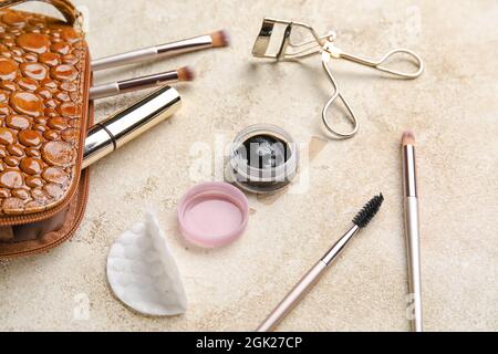 Cosmetic bag, henna, tools for eyebrows and eyelashes correction on light background Stock Photo