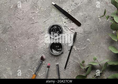 Henna and tools for eyebrows correction on grunge background Stock Photo
