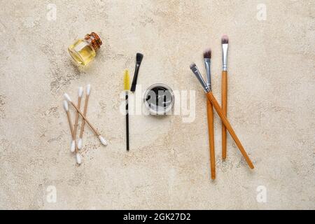 Henna and tools for eyebrows correction on color background Stock Photo