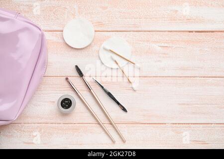 Henna and tools for eyebrows correction on color wooden background Stock Photo