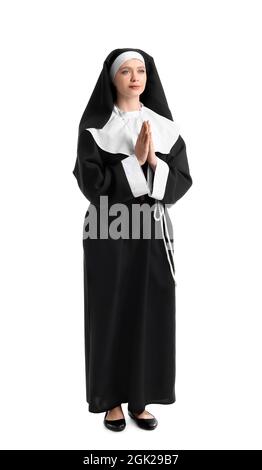 Young praying nun on white background Stock Photo