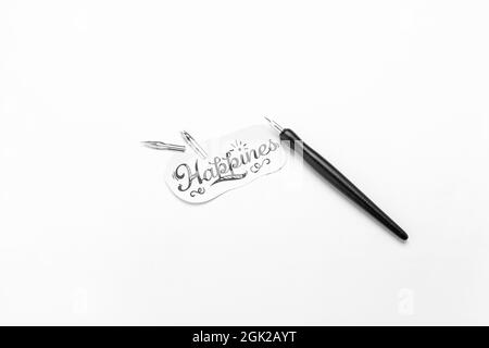Paper with word HAPPINESS and nib pen on white background Stock Photo