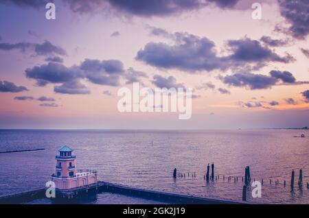 The sun sets at the Beau Rivage Marina, Sept. 5, 2021, in Biloxi, Mississippi. The marina and faux lighthouse  are part of the Beau Rivage Resort. Stock Photo