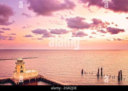 The sun sets at the Beau Rivage Marina, Sept. 5, 2021, in Biloxi, Mississippi. The marina and faux lighthouse  are part of the Beau Rivage Resort. Stock Photo