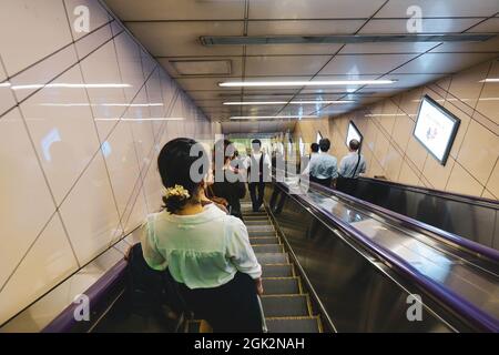 Tokyo, Japan - Sep 29, 2017. People on an escalator in the Tokyo Metro. As of October 2018, the population of Tokyo is estimated to be over 13 million Stock Photo